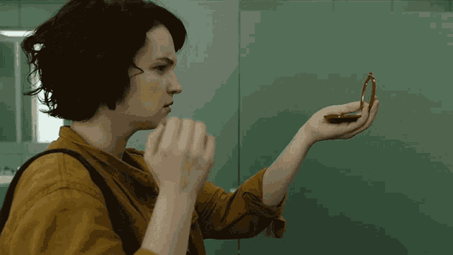 a woman looking at herself in a mirror