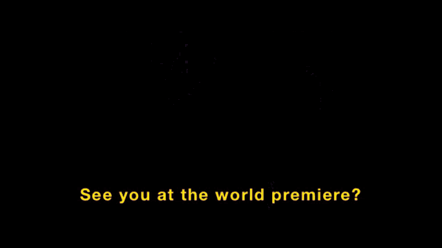 a man in a white shirt and tie talks to a woman in a blue shirt and says " see you at the world premiere "