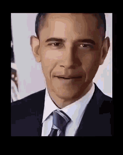 barack obama is smiling and wearing a suit and tie .