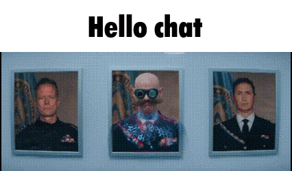 a man with a mustache and goggles is standing in front of three framed pictures on a wall .