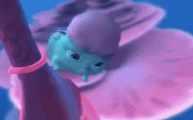 a frog is crawling on a pink and blue surface