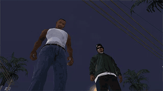 two men standing next to each other in a dark room