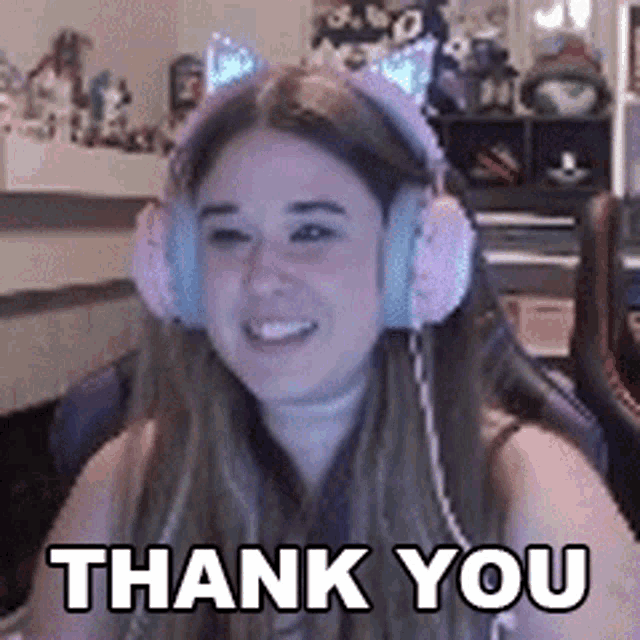 a woman wearing headphones is smiling and says thank you
