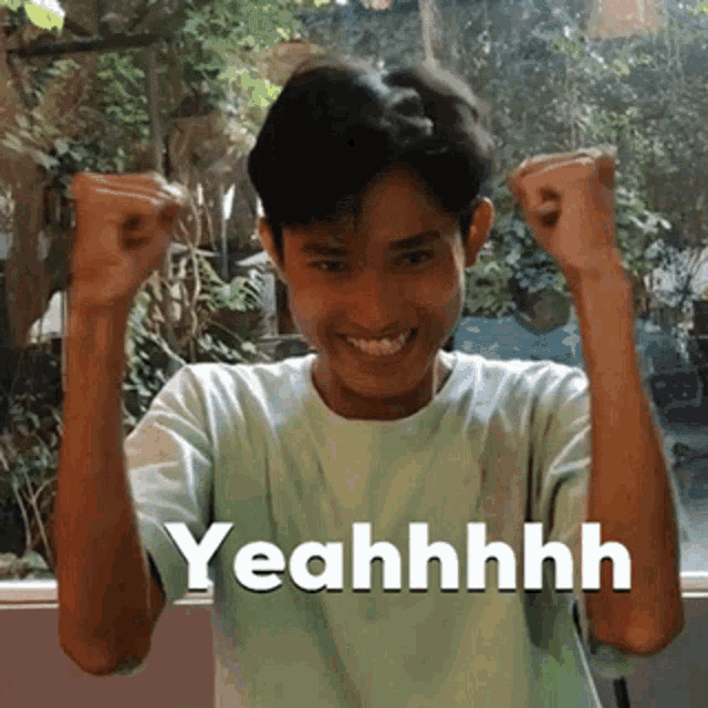 a young man with his fist in the air and the word yeahhhh written on the bottom