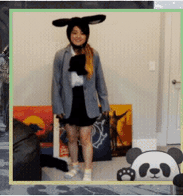 a woman wearing bunny ears and a panda bear