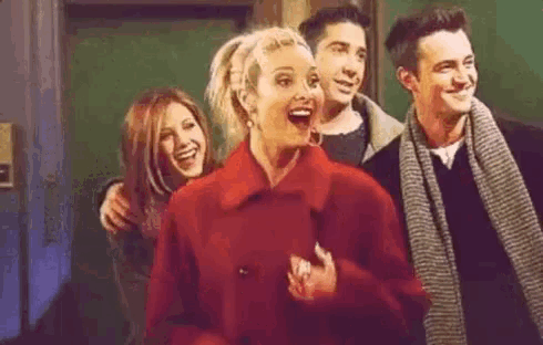 a group of people are standing next to each other in a room .