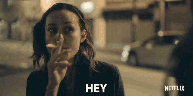 a woman is smoking a cigarette and says hey on the screen
