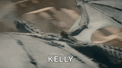 a close up of a dragon flying in the air with the words kelly written on it .