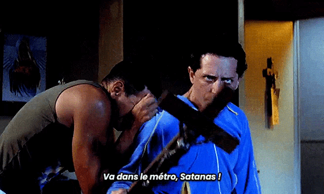 two men are standing next to each other and one of them is holding a cross in his mouth and says va dans le metro satanas