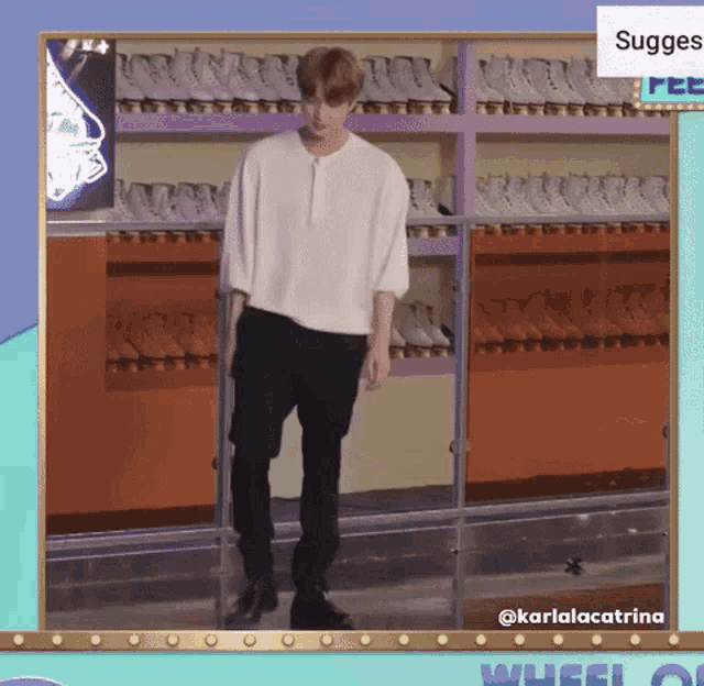 a man in a white shirt and black pants is standing in front of a roller rink