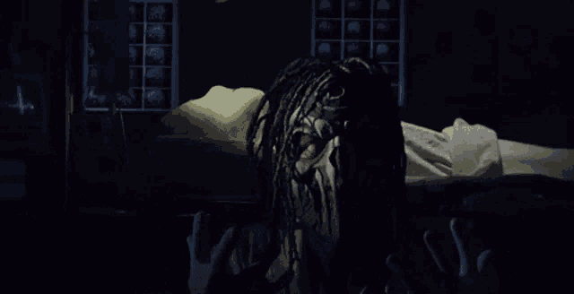 a person with dreadlocks is laying on a bed