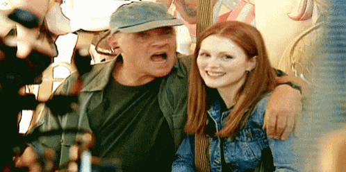 a man and a woman are posing for a picture and the man is yelling at the woman