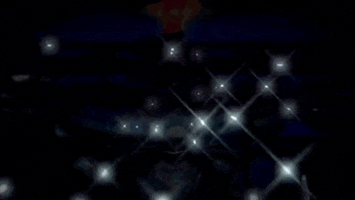 a man in a white cape stands in front of a microphone in a dark room ..