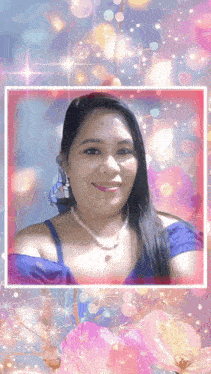 a woman in a blue top and pearl necklace is smiling in a picture frame with flowers in the background