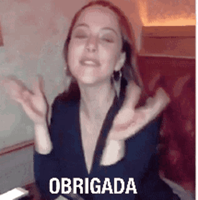 a woman is sitting in a chair with her arms outstretched and the words obrigada on the bottom