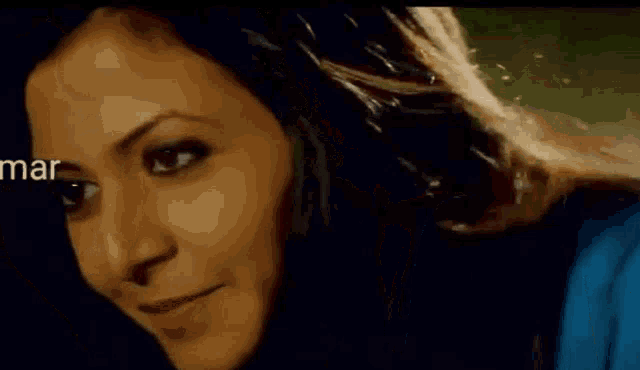 a close up of a woman 's face in a dark room .
