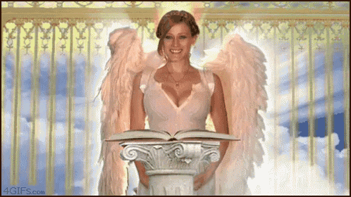 a woman with angel wings is holding an open book and smiling