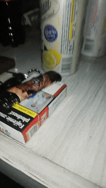 a box of cigarettes sits on a table next to a can of 100 % lemonade