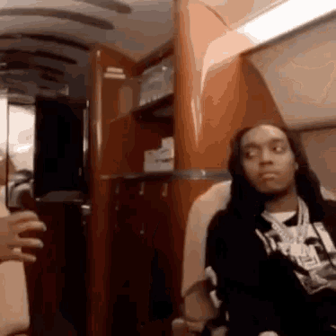 a man with long hair is sitting in a chair on a private jet .