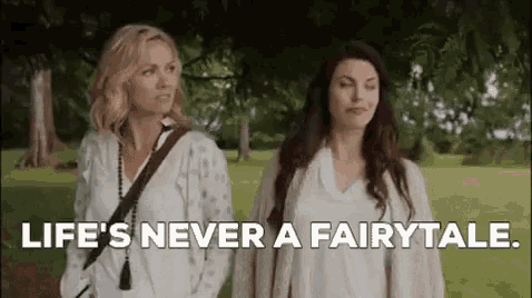 two women are standing next to each other in a park and they are talking about life .