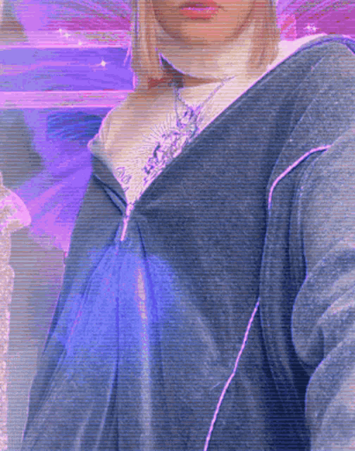 a woman wearing a purple sweater and a white turtleneck