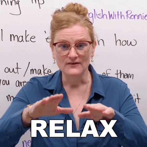 a woman in front of a white board with the word relax written on it