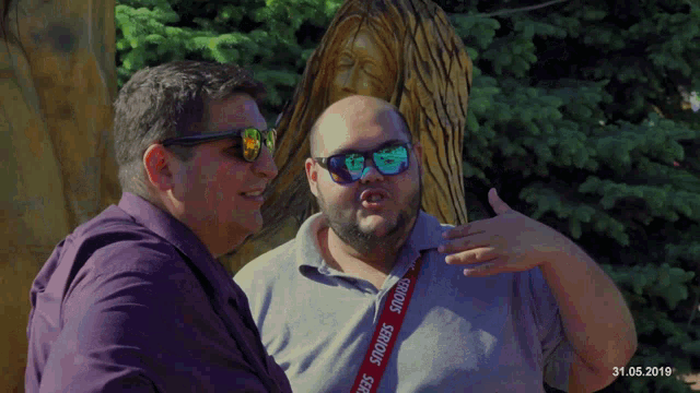 a man wearing sunglasses and a lanyard that says smokers on it