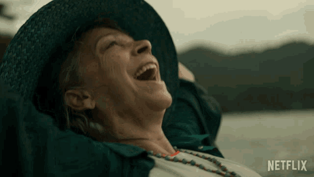 a woman with her arms outstretched and a netflix logo in the background