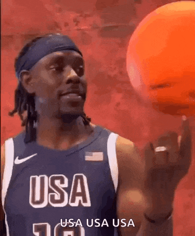 a man in a usa basketball jersey is holding a basketball .