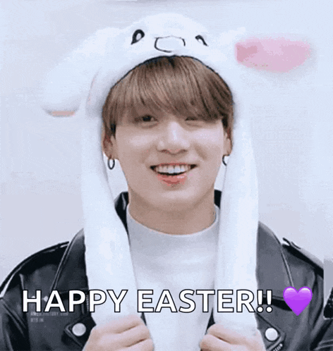 a young man wearing a bunny hat with moving ears is smiling and says happy easter !