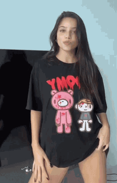 a woman wearing a black t-shirt with a pink teddy bear and a boy on it