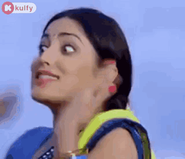 a close up of a woman making a funny face with her hand on her neck .