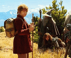 a man with a backpack is standing in a field with a group of people