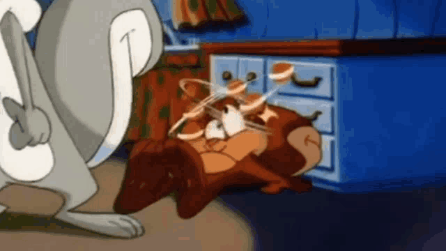 tom and jerry are fighting each other in a room .