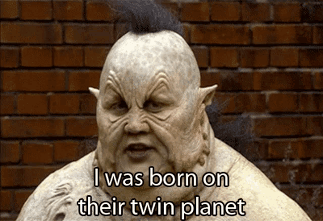 a statue with the words i was born on their twin planet