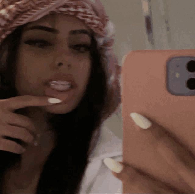 a woman is taking a picture of herself in the mirror