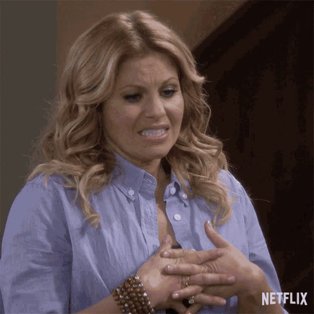 a woman in a blue shirt with a netflix logo on the bottom