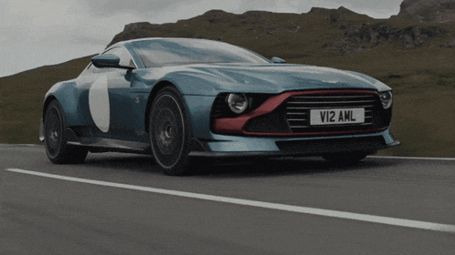a blue sports car with a license plate that says vi12 aml