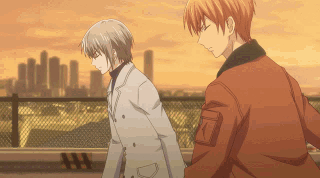 a couple of anime characters standing next to each other with a city in the background