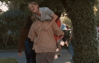 a group of people are hugging each other on the sidewalk