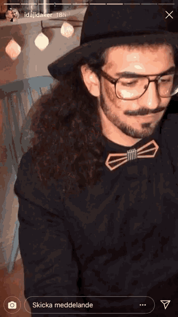 a man wearing glasses and a bow tie is displayed in a screenshot from idajidaker