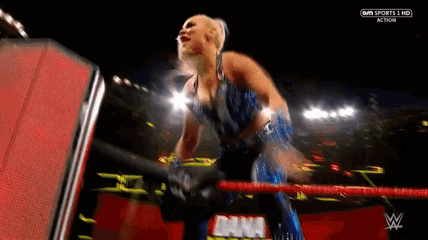 a woman in a wrestling ring with the word action on the bottom left