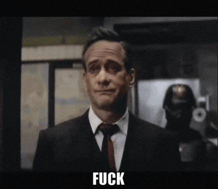 a man in a suit and tie says fuck in front of a police officer