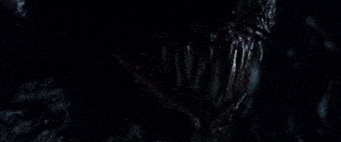a close up of a monster 's mouth with a purple colored substance coming out of it 's mouth
