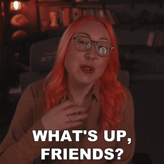 a woman with red hair and glasses is asking what 's up friends