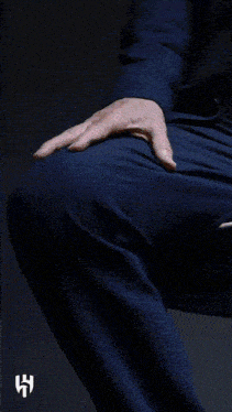 a man in a blue suit has a badge on his jacket that says ' w '