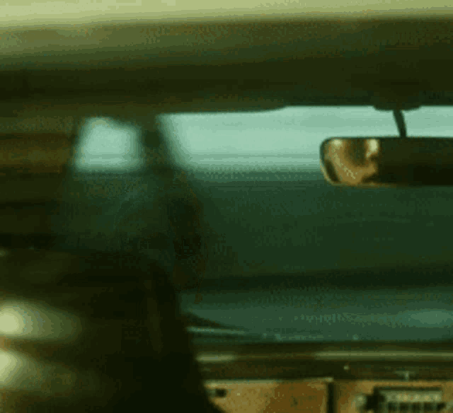 a man is giving the middle finger while sitting in a car