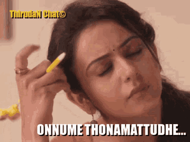 a woman is holding a pen to her ear and says " onnume thonamattudhe "