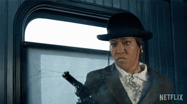 a woman holding a gun with netflix written on the bottom