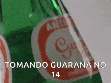 a green bottle of guarana with the words tomando guarana no 14 on it .